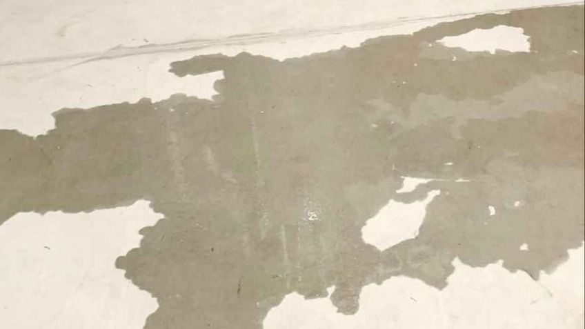 Water on a basement floor from a slab leak